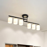 6-Light Living Room Semi Flushmount Modernism Black Ceiling Flush Mount with Cylinder Cream Glass Shade Black Clearhalo 'Ceiling Lights' 'Close To Ceiling Lights' 'Close to ceiling' 'Glass shade' 'Glass' 'Pendant Lights' 'Semi-flushmount' Lighting' 520635