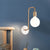Gold Sphere Sconce Light Fixture Modernism 1-Head Cream Glass Wall Mounted Lamp with Right Angle Arm Gold Clearhalo 'Cast Iron' 'Glass' 'Industrial' 'Modern wall lights' 'Modern' 'Tiffany' 'Traditional wall lights' 'Wall Lamps & Sconces' 'Wall Lights' Lighting' 520731