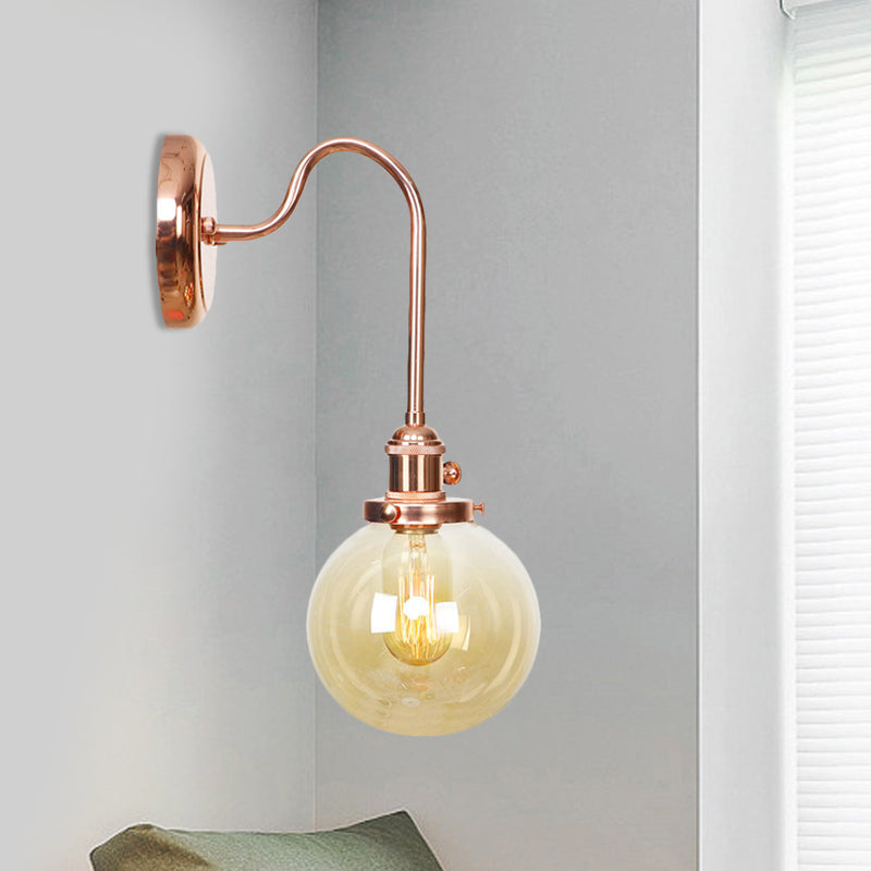 Vintage Globe Wall Lighting 1 Light Clear/Amber Glass Sconce in Copper with Curved Arm Amber A Clearhalo 'Art deco wall lights' 'Cast Iron' 'Glass' 'Industrial wall lights' 'Industrial' 'Middle century wall lights' 'Modern' 'Rustic wall lights' 'Tiffany' 'Traditional wall lights' 'Wall Lamps & Sconces' 'Wall Lights' Lighting' 521301