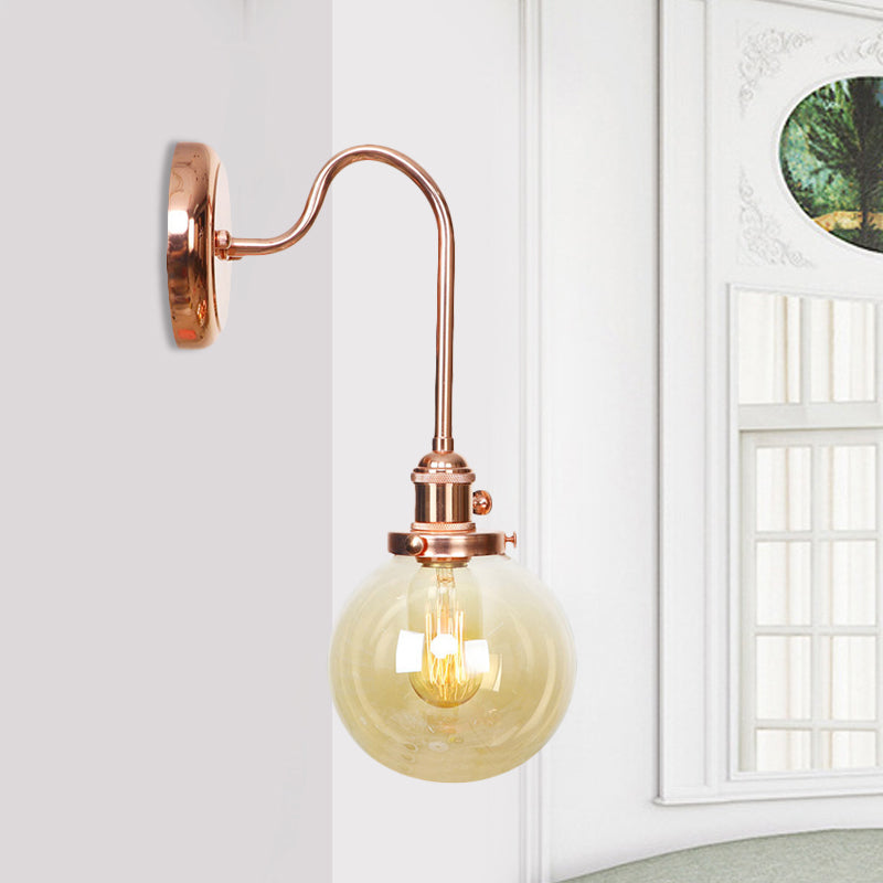 Vintage Globe Wall Lighting 1 Light Clear/Amber Glass Sconce in Copper with Curved Arm Clearhalo 'Art deco wall lights' 'Cast Iron' 'Glass' 'Industrial wall lights' 'Industrial' 'Middle century wall lights' 'Modern' 'Rustic wall lights' 'Tiffany' 'Traditional wall lights' 'Wall Lamps & Sconces' 'Wall Lights' Lighting' 521302