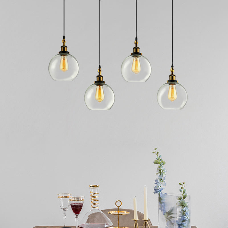 3/4-Light Clear Glass Multi Hanging Light Fixture Industrial Antique Brass Orb Living Room Pendant with Round Canopy Clearhalo 'Ceiling Lights' 'Glass shade' 'Glass' 'Industrial Pendants' 'Industrial' 'Middle Century Pendants' 'Pendant Lights' 'Pendants' 'Tiffany' Lighting' 678256