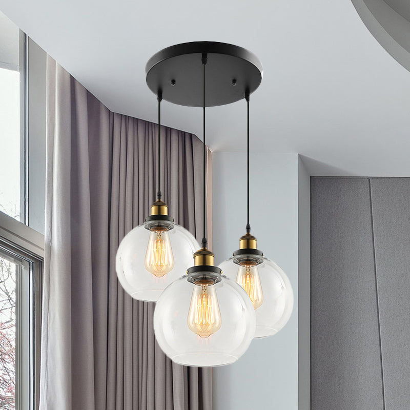 3/4-Light Clear Glass Multi Hanging Light Fixture Industrial Antique Brass Orb Living Room Pendant with Round Canopy Clearhalo 'Ceiling Lights' 'Glass shade' 'Glass' 'Industrial Pendants' 'Industrial' 'Middle Century Pendants' 'Pendant Lights' 'Pendants' 'Tiffany' Lighting' 678257