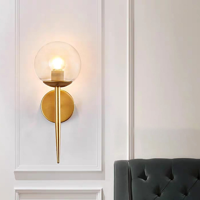 Clear Glass Globe Wall Sconce Modern 1 Light Living Room Lighting Fixture in Gold Clearhalo 'Cast Iron' 'Glass' 'Industrial wall lights' 'Industrial' 'Middle century wall lights' 'Modern' 'Tiffany' 'Traditional wall lights' 'Wall Lamps & Sconces' 'Wall Lights' Lighting' 679169