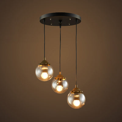 Orb Clear Glass Multi-Light Pendant Modern 3-Light Coffee Shop Hanging Lamp in Black with Linear/Round Canopy Black Round Clearhalo 'Ceiling Lights' 'Glass shade' 'Glass' 'Industrial Pendants' 'Industrial' 'Middle Century Pendants' 'Pendant Lights' 'Pendants' 'Tiffany' Lighting' 70093