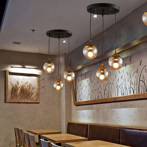 Orb Clear Glass Multi-Light Pendant Modern 3-Light Coffee Shop Hanging Lamp in Black with Linear/Round Canopy Clearhalo 'Ceiling Lights' 'Glass shade' 'Glass' 'Industrial Pendants' 'Industrial' 'Middle Century Pendants' 'Pendant Lights' 'Pendants' 'Tiffany' Lighting' 70094