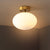 Gold Oval Semi Flush Light Fixture Minimalist 1-Light Cream Glass Close to Ceiling Lamp for Bedroom Gold Clearhalo 'Ceiling Lights' 'Close To Ceiling Lights' 'Close to ceiling' 'Glass shade' 'Glass' 'Pendant Lights' 'Semi-flushmount' Lighting' 730542