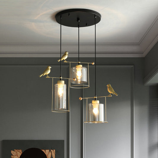 Cylinder Dining Room Cluster Pendant Cream/Smoke Gray Glass 3 Bulbs Modernism Suspension Lamp with Gold Bird Deco Smoke Gray Clearhalo 'Ceiling Lights' 'Chandeliers' 'Glass shade' 'Glass' 'Modern Pendants' 'Modern' 'Pendant Lights' 'Pendants' Lighting' 731486