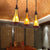 Brown Bottle Cluster Pendant Light Warehouse Yellow/White Glass 3 Heads Dining Room Ceiling Fixture with Wood Linear Canopy Yellow Clearhalo 'Art Deco Pendants' 'Cast Iron' 'Ceiling Lights' 'Ceramic' 'Crystal' 'Industrial Pendants' 'Industrial' 'Metal' 'Middle Century Pendants' 'Pendant Lights' 'Pendants' 'Tiffany' Lighting' 736176
