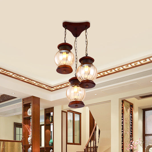 Factory Lantern Cluster Pendant 3-Bulb Tan Glass Suspension Lighting in Copper with Wood Triangle Canopy Copper Clearhalo 'Ceiling Lights' 'Glass shade' 'Glass' 'Industrial Pendants' 'Industrial' 'Middle Century Pendants' 'Pendant Lights' 'Pendants' 'Tiffany' Lighting' 736192