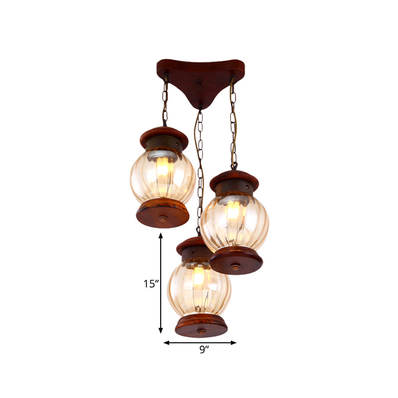 Factory Lantern Cluster Pendant 3-Bulb Tan Glass Suspension Lighting in Copper with Wood Triangle Canopy Clearhalo 'Ceiling Lights' 'Glass shade' 'Glass' 'Industrial Pendants' 'Industrial' 'Middle Century Pendants' 'Pendant Lights' 'Pendants' 'Tiffany' Lighting' 736195