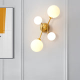 Modernism 4-Light Sconce Lighting with Cream Glass Shade Black/Gold Finish Orb Wall Mounted Lamp Fixture Clearhalo 'Cast Iron' 'Glass' 'Industrial' 'Modern wall lights' 'Modern' 'Tiffany' 'Traditional wall lights' 'Wall Lamps & Sconces' 'Wall Lights' Lighting' 759026