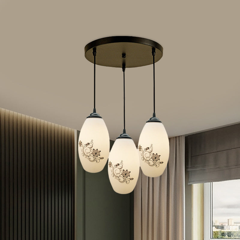 3 Lights Oval Multi-Pendant Modern Black Finish White Printed Glass Ceiling Hang Fixture with Round/Linear Canopy Clearhalo 'Ceiling Lights' 'Close To Ceiling Lights' 'Glass shade' 'Glass' 'Pendant Lights' 'Pendants' Lighting' 802122