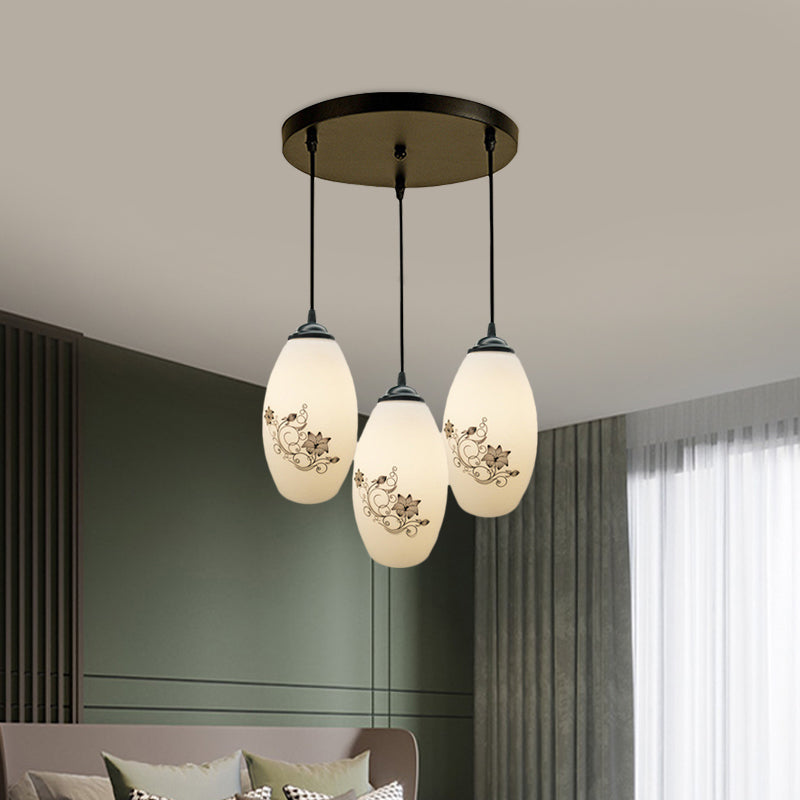 3 Lights Oval Multi-Pendant Modern Black Finish White Printed Glass Ceiling Hang Fixture with Round/Linear Canopy Clearhalo 'Ceiling Lights' 'Close To Ceiling Lights' 'Glass shade' 'Glass' 'Pendant Lights' 'Pendants' Lighting' 802123