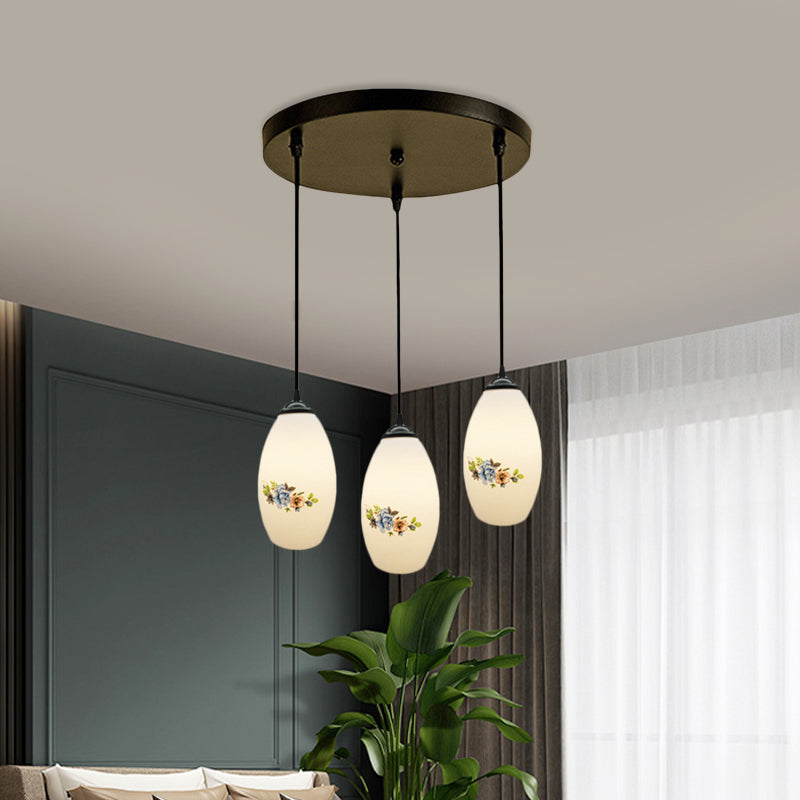 3 Lights Oval Multi-Pendant Modern Black Finish White Printed Glass Ceiling Hang Fixture with Round/Linear Canopy Clearhalo 'Ceiling Lights' 'Close To Ceiling Lights' 'Glass shade' 'Glass' 'Pendant Lights' 'Pendants' Lighting' 802127