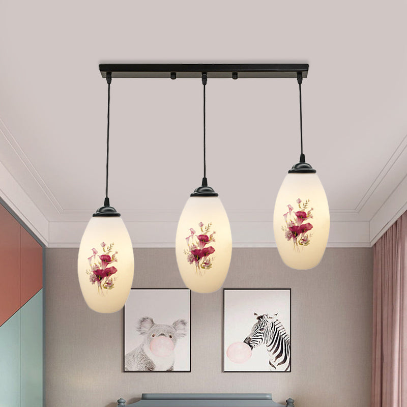 3 Lights Oval Multi-Pendant Modern Black Finish White Printed Glass Ceiling Hang Fixture with Round/Linear Canopy Clearhalo 'Ceiling Lights' 'Close To Ceiling Lights' 'Glass shade' 'Glass' 'Pendant Lights' 'Pendants' Lighting' 802134