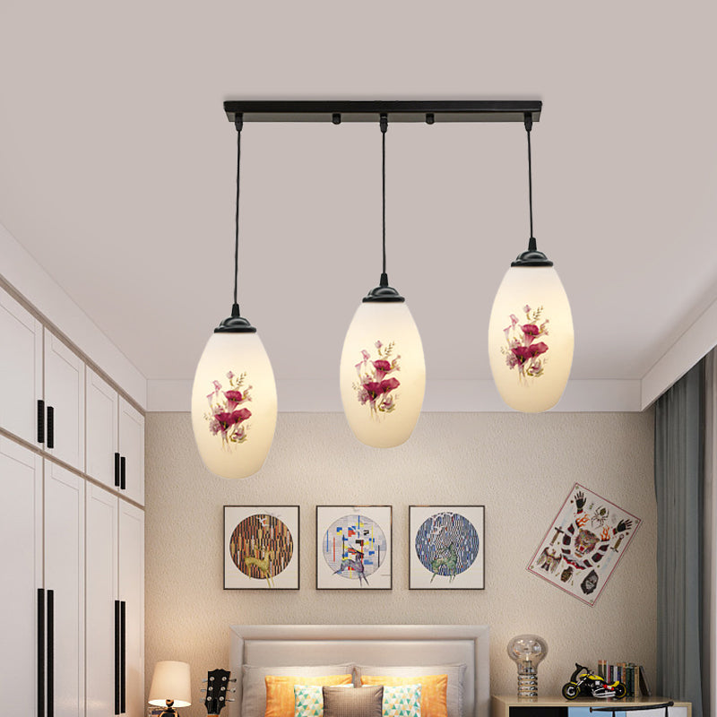 3 Lights Oval Multi-Pendant Modern Black Finish White Printed Glass Ceiling Hang Fixture with Round/Linear Canopy Clearhalo 'Ceiling Lights' 'Close To Ceiling Lights' 'Glass shade' 'Glass' 'Pendant Lights' 'Pendants' Lighting' 802135