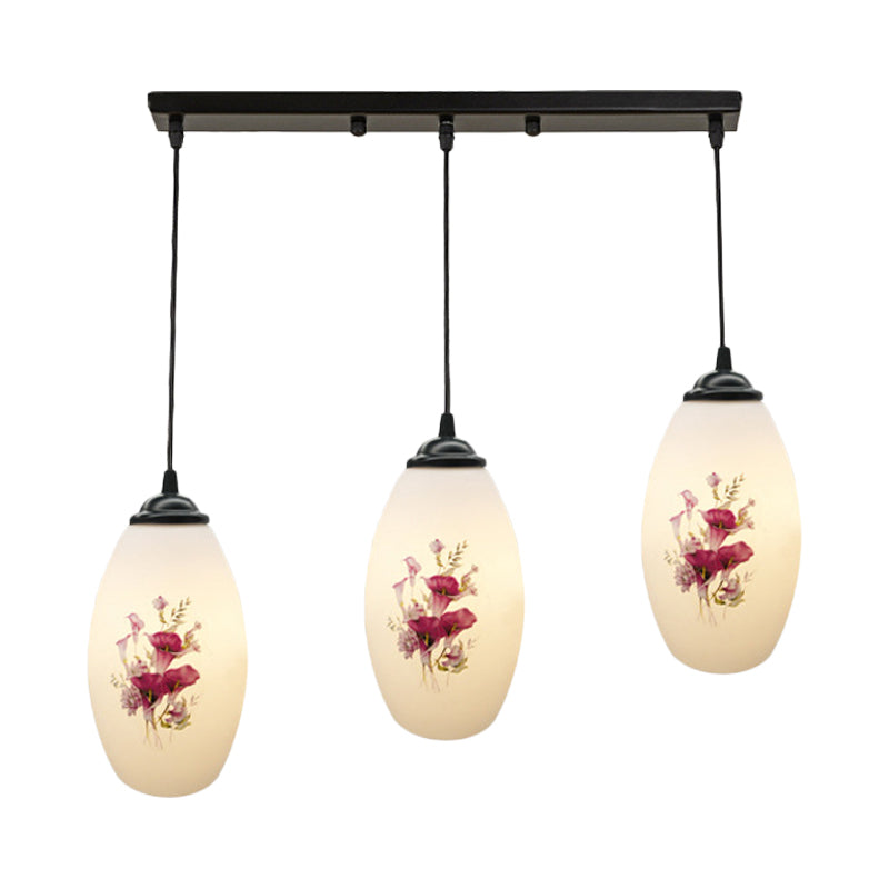 3 Lights Oval Multi-Pendant Modern Black Finish White Printed Glass Ceiling Hang Fixture with Round/Linear Canopy Clearhalo 'Ceiling Lights' 'Close To Ceiling Lights' 'Glass shade' 'Glass' 'Pendant Lights' 'Pendants' Lighting' 802136