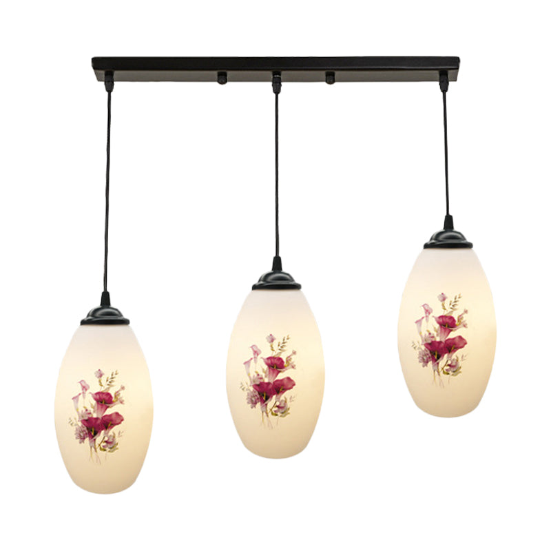 3 Lights Oval Multi-Pendant Modern Black Finish White Printed Glass Ceiling Hang Fixture with Round/Linear Canopy Clearhalo 'Ceiling Lights' 'Close To Ceiling Lights' 'Glass shade' 'Glass' 'Pendant Lights' 'Pendants' Lighting' 802136