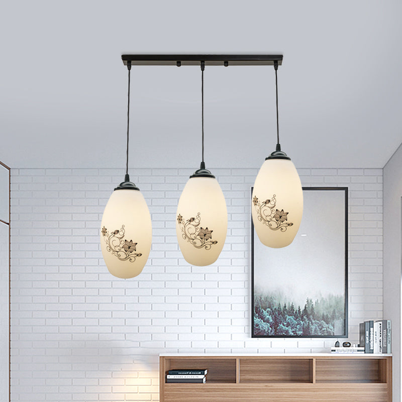 3 Lights Oval Multi-Pendant Modern Black Finish White Printed Glass Ceiling Hang Fixture with Round/Linear Canopy Clearhalo 'Ceiling Lights' 'Close To Ceiling Lights' 'Glass shade' 'Glass' 'Pendant Lights' 'Pendants' Lighting' 802140