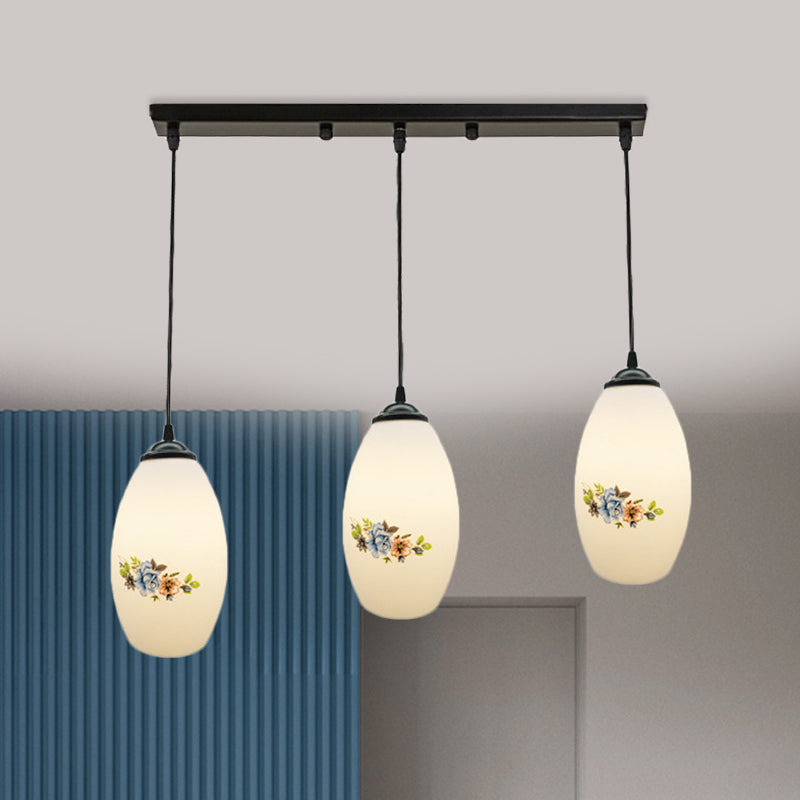 3 Lights Oval Multi-Pendant Modern Black Finish White Printed Glass Ceiling Hang Fixture with Round/Linear Canopy White A Linear Clearhalo 'Ceiling Lights' 'Close To Ceiling Lights' 'Glass shade' 'Glass' 'Pendant Lights' 'Pendants' Lighting' 802142