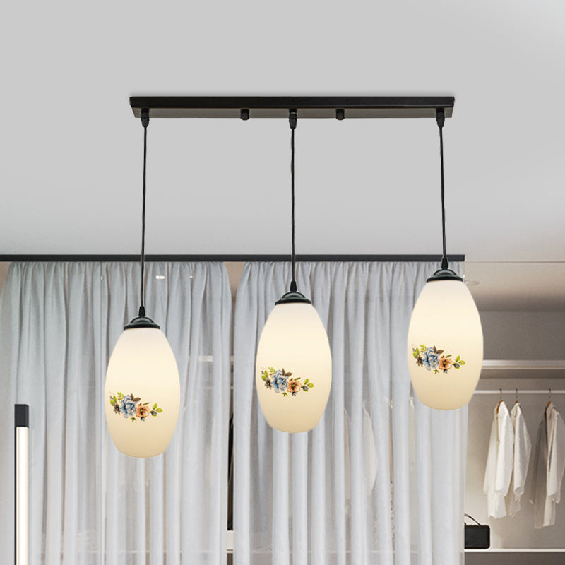 3 Lights Oval Multi-Pendant Modern Black Finish White Printed Glass Ceiling Hang Fixture with Round/Linear Canopy Clearhalo 'Ceiling Lights' 'Close To Ceiling Lights' 'Glass shade' 'Glass' 'Pendant Lights' 'Pendants' Lighting' 802143