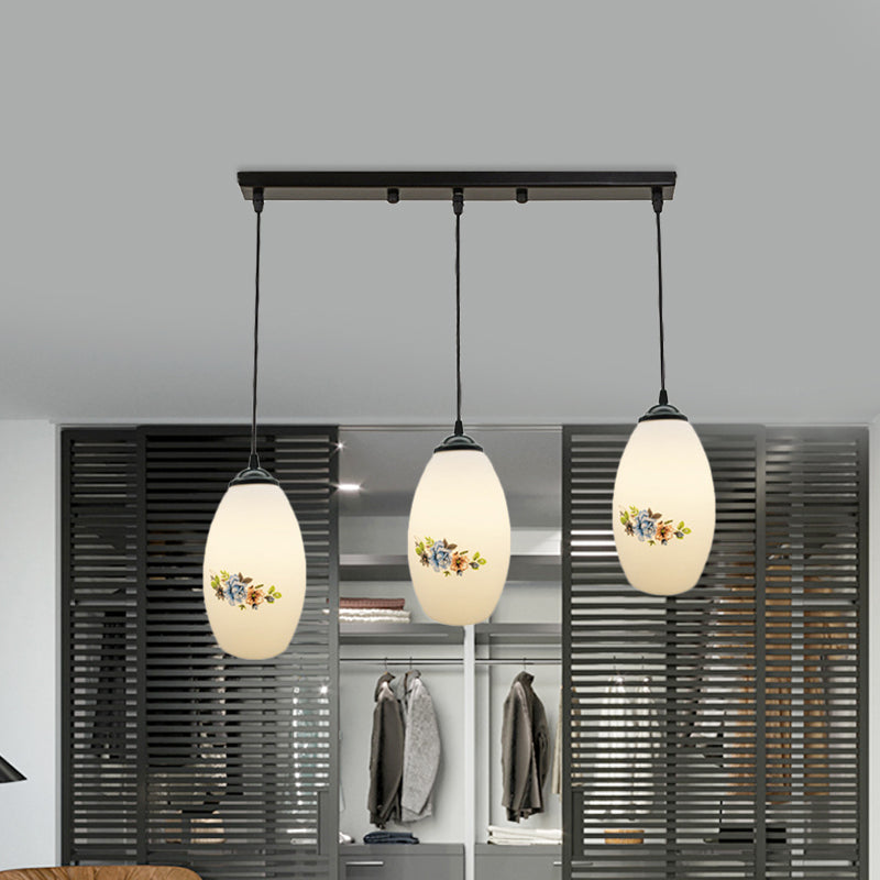 3 Lights Oval Multi-Pendant Modern Black Finish White Printed Glass Ceiling Hang Fixture with Round/Linear Canopy Clearhalo 'Ceiling Lights' 'Close To Ceiling Lights' 'Glass shade' 'Glass' 'Pendant Lights' 'Pendants' Lighting' 802144