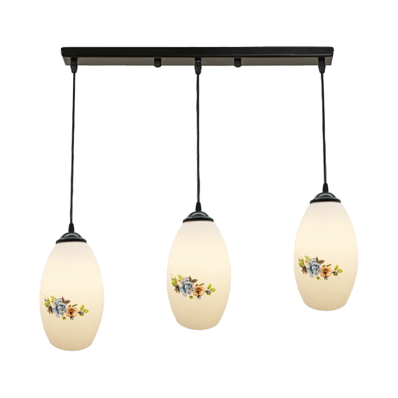 3 Lights Oval Multi-Pendant Modern Black Finish White Printed Glass Ceiling Hang Fixture with Round/Linear Canopy Clearhalo 'Ceiling Lights' 'Close To Ceiling Lights' 'Glass shade' 'Glass' 'Pendant Lights' 'Pendants' Lighting' 802145