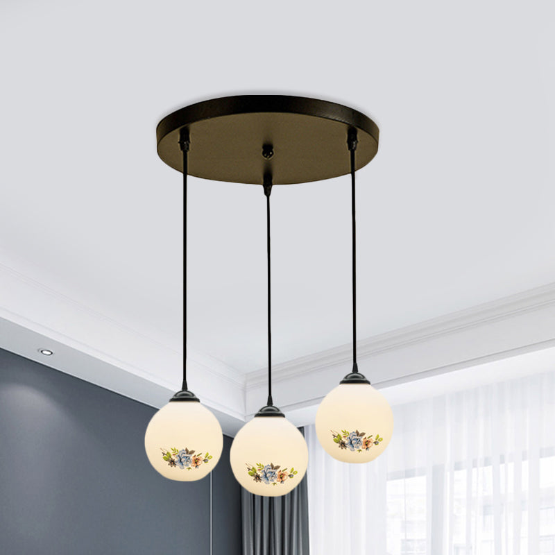 3 Heads Orb Multi-Pendant Modernism Black Finish White Frosted Glass Hanging Light Kit with Flower Pattern and Round/Linear Canopy White A Round Clearhalo 'Ceiling Lights' 'Glass shade' 'Glass' 'Pendant Lights' 'Pendants' Lighting' 802262