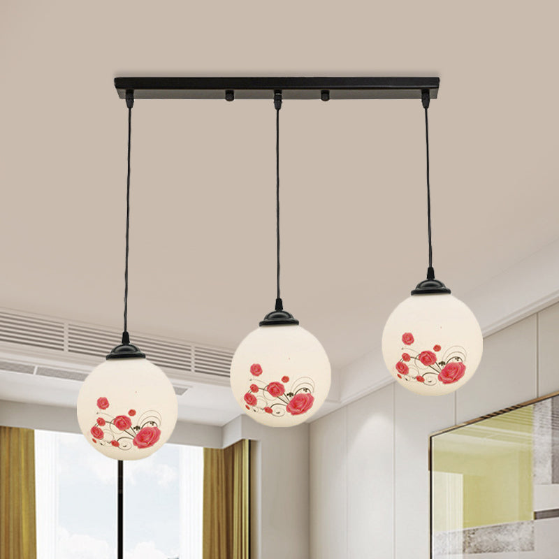 3 Heads Orb Multi-Pendant Modernism Black Finish White Frosted Glass Hanging Light Kit with Flower Pattern and Round/Linear Canopy White C Linear Clearhalo 'Ceiling Lights' 'Glass shade' 'Glass' 'Pendant Lights' 'Pendants' Lighting' 802266