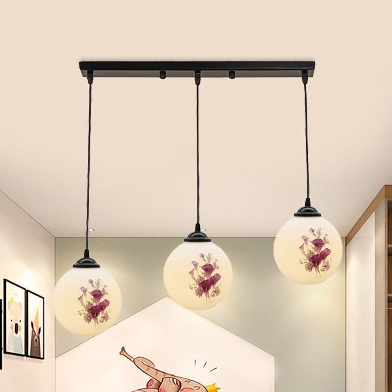 3 Heads Orb Multi-Pendant Modernism Black Finish White Frosted Glass Hanging Light Kit with Flower Pattern and Round/Linear Canopy White B Linear Clearhalo 'Ceiling Lights' 'Glass shade' 'Glass' 'Pendant Lights' 'Pendants' Lighting' 802271