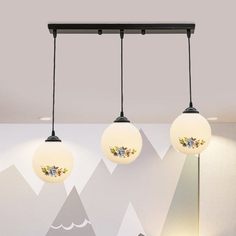 3 Heads Orb Multi-Pendant Modernism Black Finish White Frosted Glass Hanging Light Kit with Flower Pattern and Round/Linear Canopy White A Linear Clearhalo 'Ceiling Lights' 'Glass shade' 'Glass' 'Pendant Lights' 'Pendants' Lighting' 802275