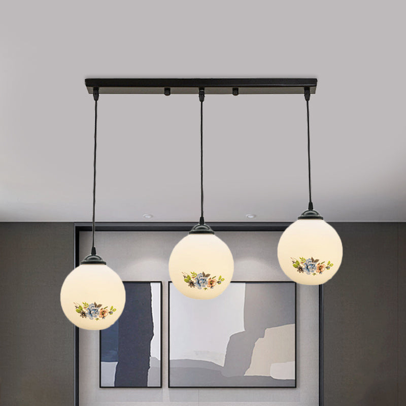 3 Heads Orb Multi-Pendant Modernism Black Finish White Frosted Glass Hanging Light Kit with Flower Pattern and Round/Linear Canopy Clearhalo 'Ceiling Lights' 'Glass shade' 'Glass' 'Pendant Lights' 'Pendants' Lighting' 802276