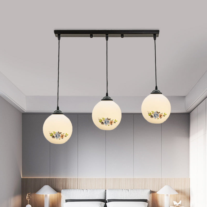 3 Heads Orb Multi-Pendant Modernism Black Finish White Frosted Glass Hanging Light Kit with Flower Pattern and Round/Linear Canopy Clearhalo 'Ceiling Lights' 'Glass shade' 'Glass' 'Pendant Lights' 'Pendants' Lighting' 802277