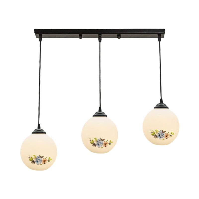3 Heads Orb Multi-Pendant Modernism Black Finish White Frosted Glass Hanging Light Kit with Flower Pattern and Round/Linear Canopy Clearhalo 'Ceiling Lights' 'Glass shade' 'Glass' 'Pendant Lights' 'Pendants' Lighting' 802278