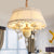 5 Bulbs Candlestick Hanging Light Pastoral Style Pink/Blue/Light-Beige Ceramic Chandelier with Pleated Lamp Shade Light Beige Clearhalo 'Ceiling Lights' 'Chandeliers' Lighting' options 889242_a7aaf769-1310-49db-b9fe-a91917b3e65f