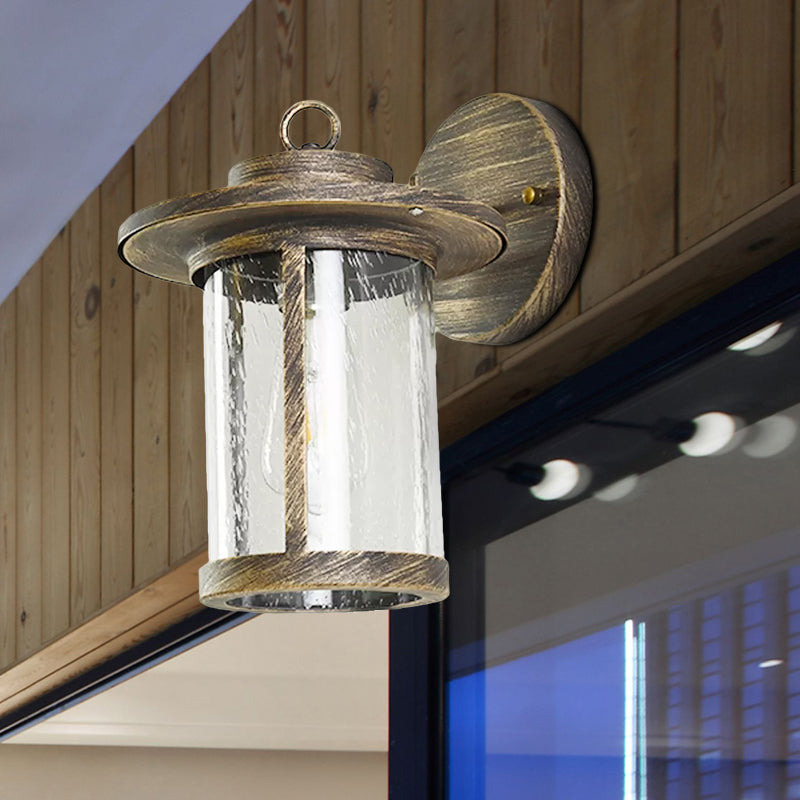 Cylinder Seeded Glass Wall Mounted Lamp Industrial Single Bulb Porch Sconce Light in Matte Black/Bronze with Cage Clearhalo 'Art deco wall lights' 'Cast Iron' 'Glass' 'Industrial wall lights' 'Industrial' 'Middle century wall lights' 'Modern' 'Rustic wall lights' 'Tiffany' 'Traditional wall lights' 'Wall Lamps & Sconces' 'Wall Lights' Lighting' 968923